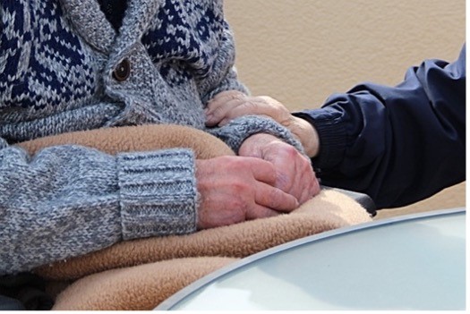 Touching elderly hands